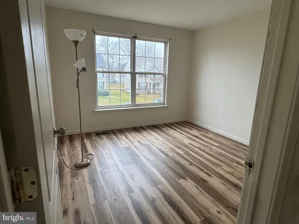 a spacious bathroom with a sink a toilet and a mirror