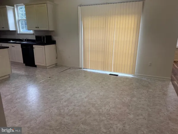 a kitchen with stainless steel appliances granite countertop a stove a refrigerator a sink a counter space and cabinets