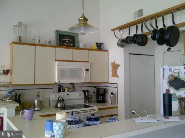 a kitchen with stainless steel appliances kitchen island granite countertop a sink a stove and cabinets