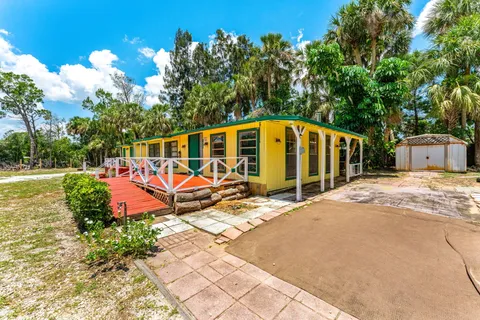 a view of balcony with wooden floor and fence