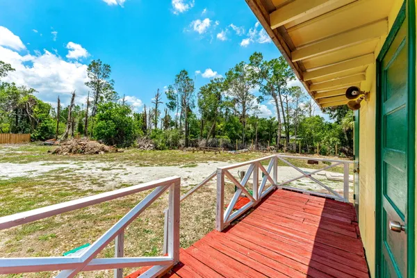 a view of backyard with green space and seating area