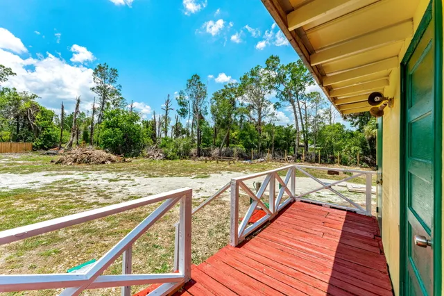 a view of backyard with green space and seating area