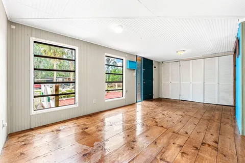 a living room with furniture large window and flat screen tv