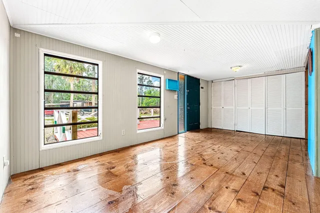 a living room with furniture large window and flat screen tv