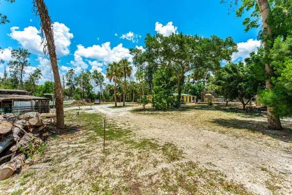 a kitchen with stainless steel appliances a stove a refrigerator cabinets and a dining table