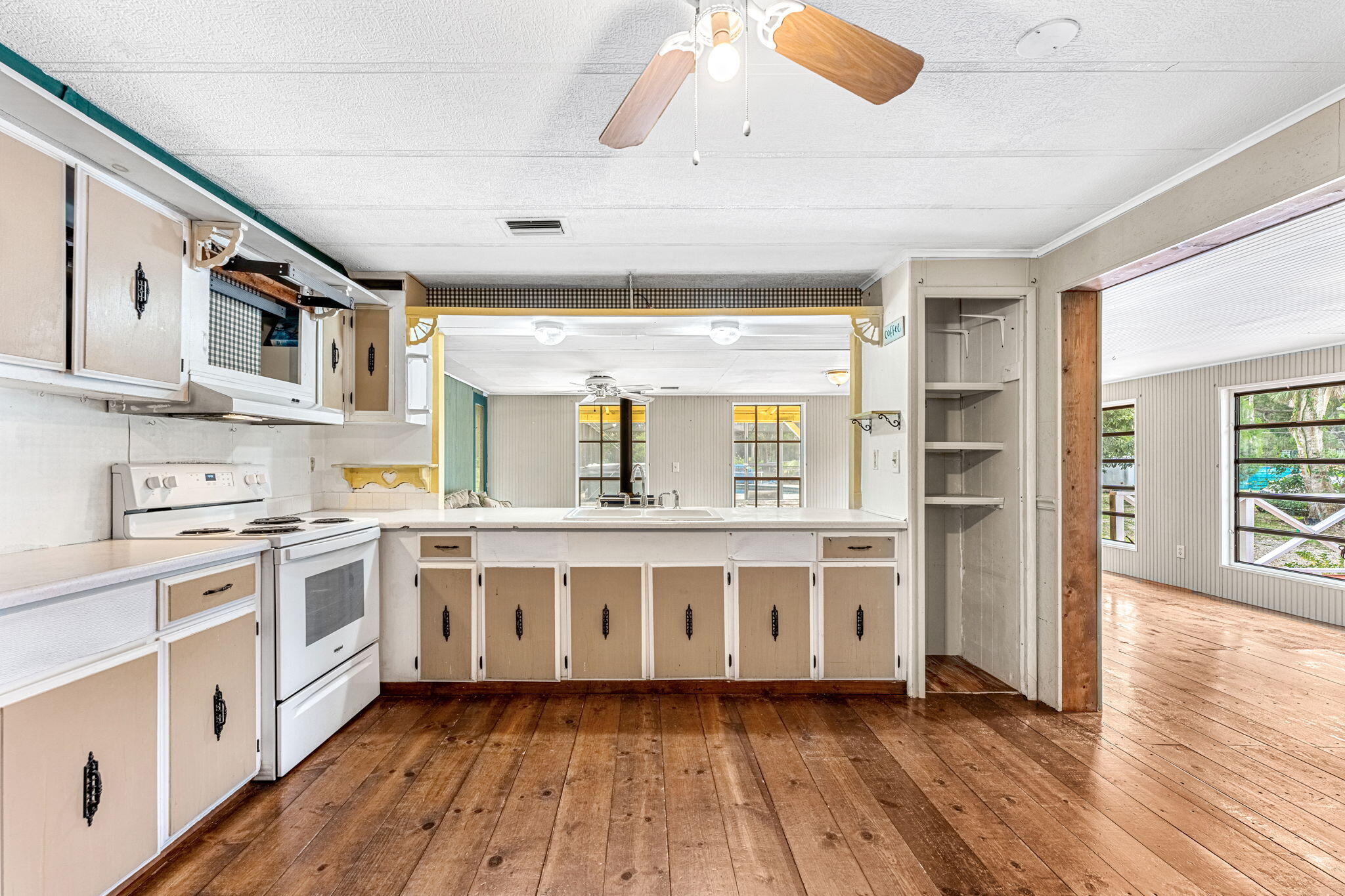 7680 Highway 1 Micco, FL 32976 - Photo 59 of 84 a large white kitchen with stainless steel appliances granite countertop a stove and a large window