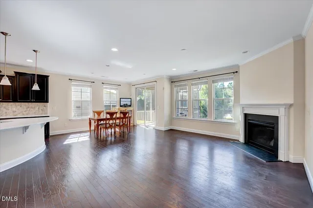 a view of dining room with furniture fireplace and wooden floor