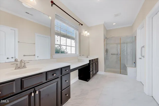 a bathroom with a granite countertop sink mirror and a shower