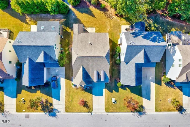 an aerial view of residential houses with outdoor space