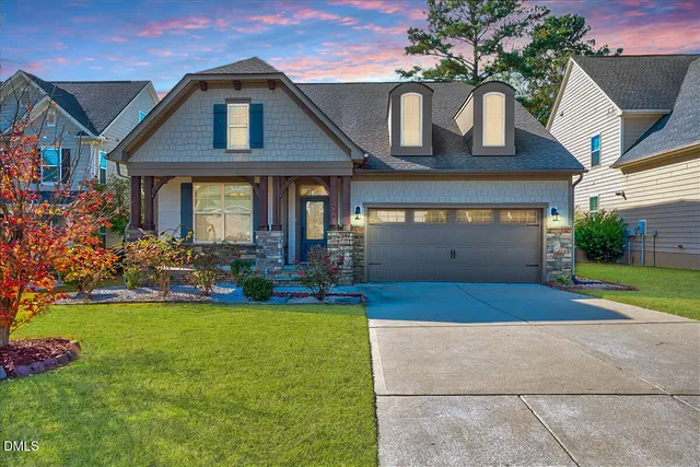 a front view of a house with garden