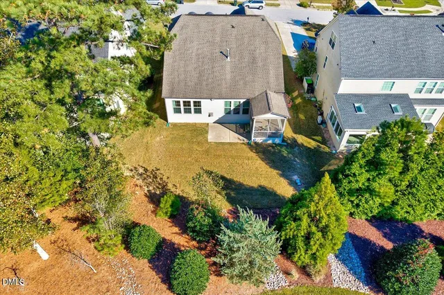 an aerial view of a house with swimming pool and garden
