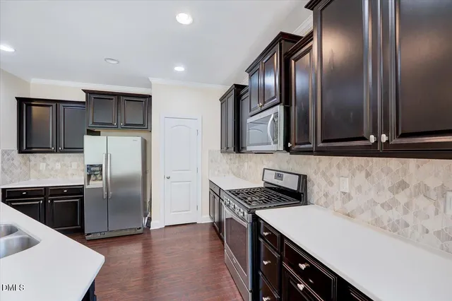 a kitchen with stainless steel appliances a sink a stove and a refrigerator