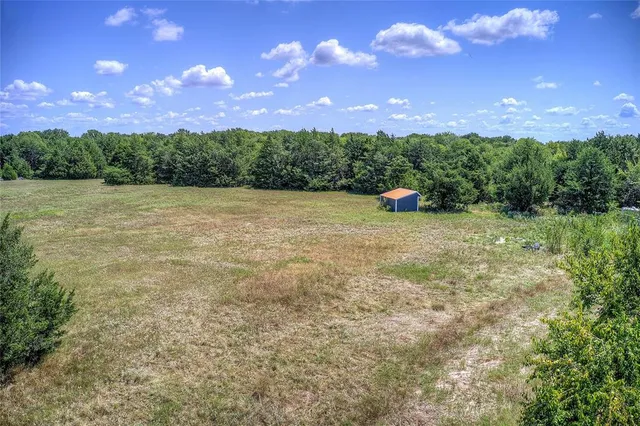 a view of a big yard with lots of green space and mountain view
