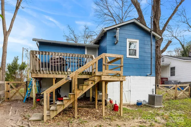 a view of house with a yard and seating space