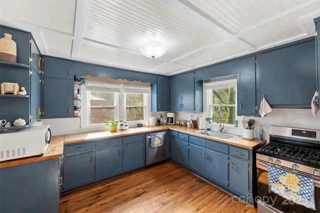 a kitchen with stainless steel appliances granite countertop sink stove and cabinets