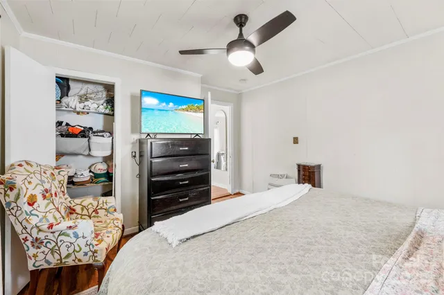 a bedroom with a bed and a television