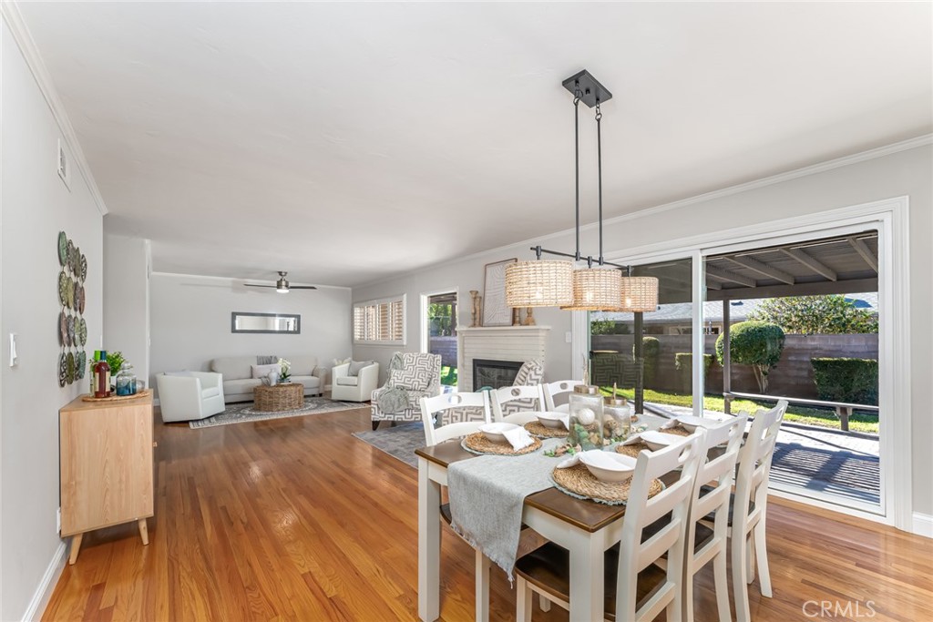 a view of a dining room with furniture wooden floor and a chandelier