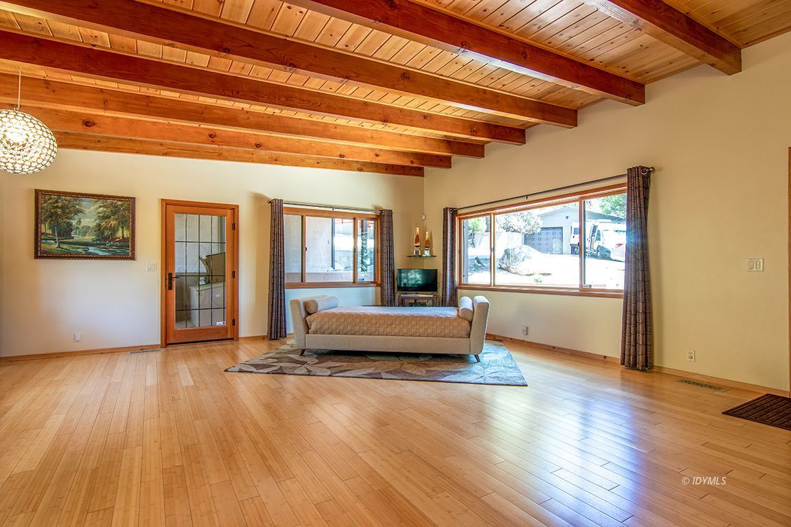 55596 Encino Road Idyllwild, CA 92549 - Photo 12 of 74 a view of an empty room with wooden floor and a window