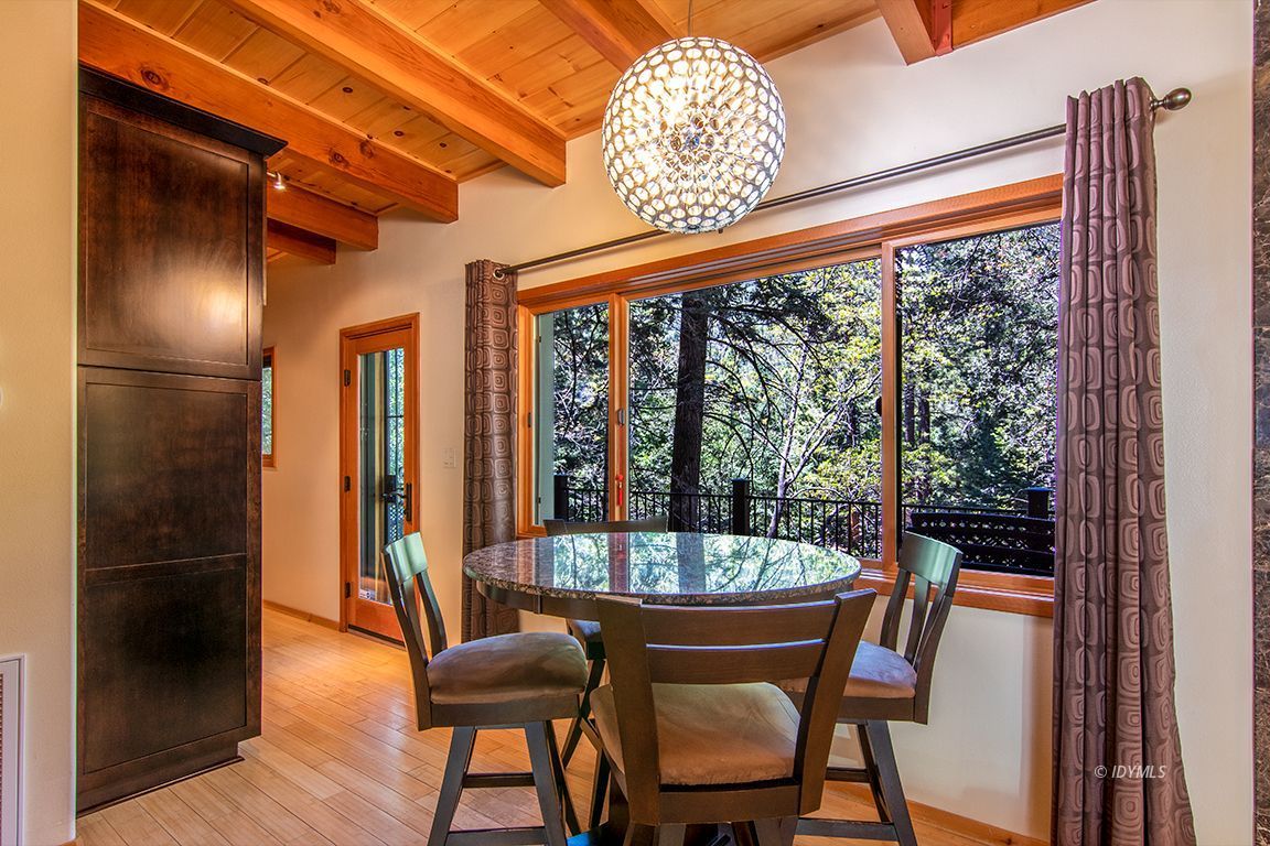 55596 Encino Road Idyllwild, CA 92549 - Photo 13 of 74 a dining room with furniture and a floor to ceiling window