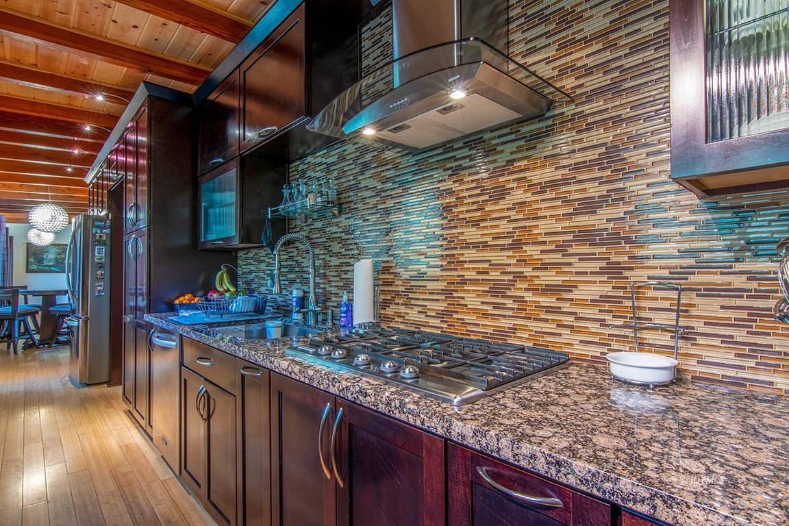 55596 Encino Road Idyllwild, CA 92549 - Photo 19 of 74 a kitchen with stainless steel appliances granite countertop a sink stove and cabinets