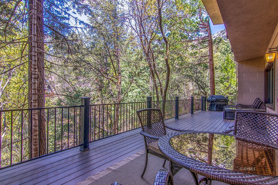 55596 Encino Road Idyllwild, CA 92549 - Photo 20 of 74 a view of a patio with furniture and wooden floor