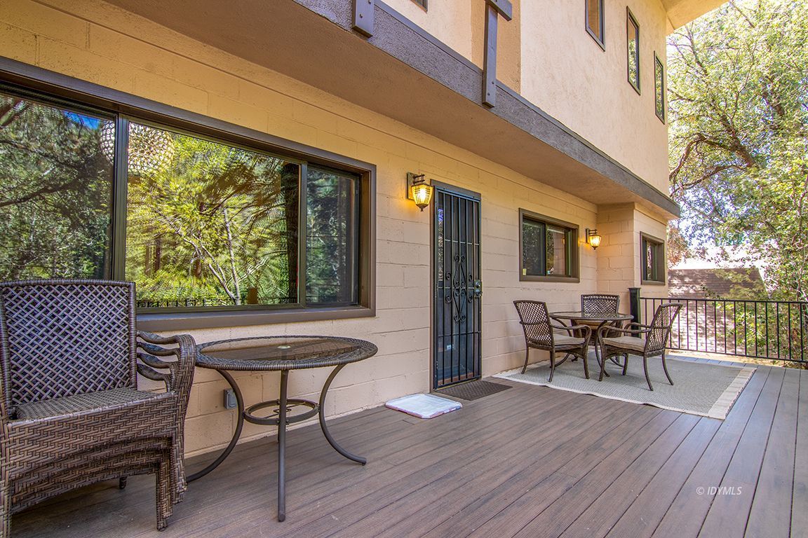 55596 Encino Road Idyllwild, CA 92549 - Photo 26 of 74 a balcony with chairs and wooden floor