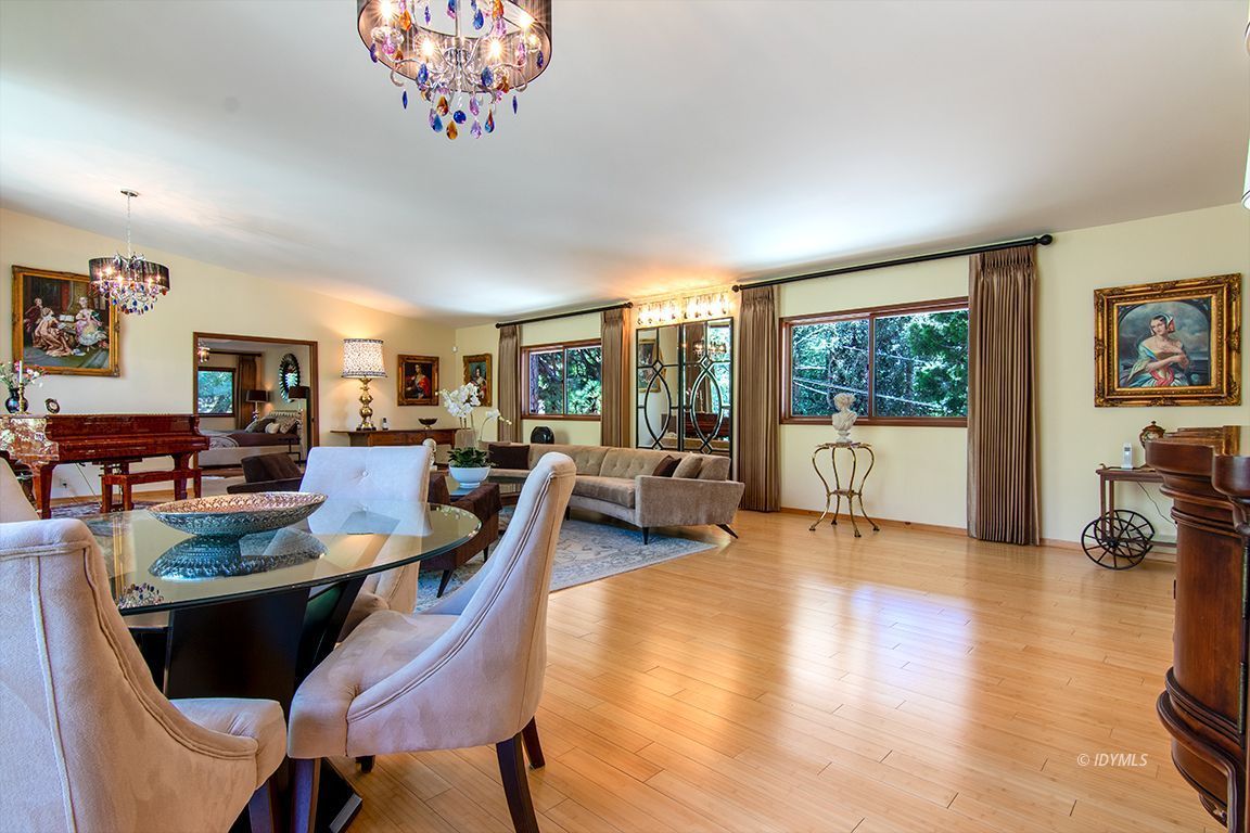 55596 Encino Road Idyllwild, CA 92549 - Photo 32 of 74 a view of a dining room with furniture a chandelier and wooden floor
