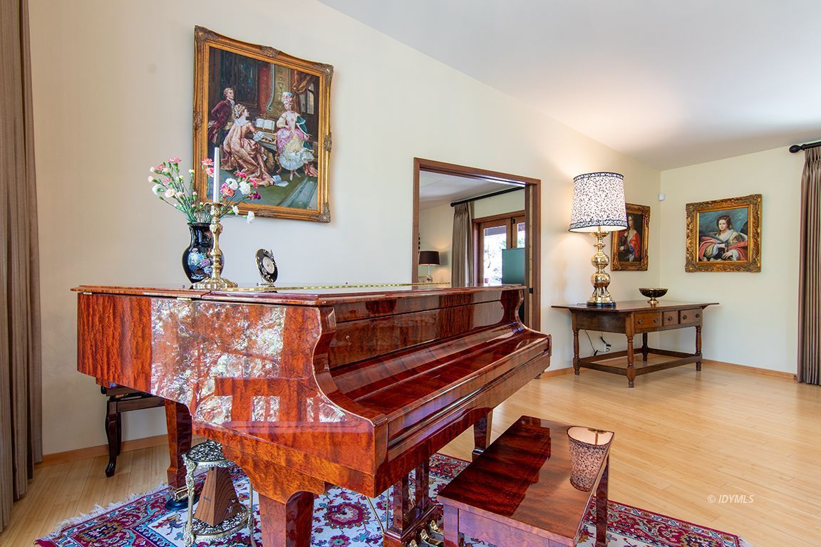 55596 Encino Road Idyllwild, CA 92549 - Photo 38 of 74 a living room with furniture a rug and a wall painting