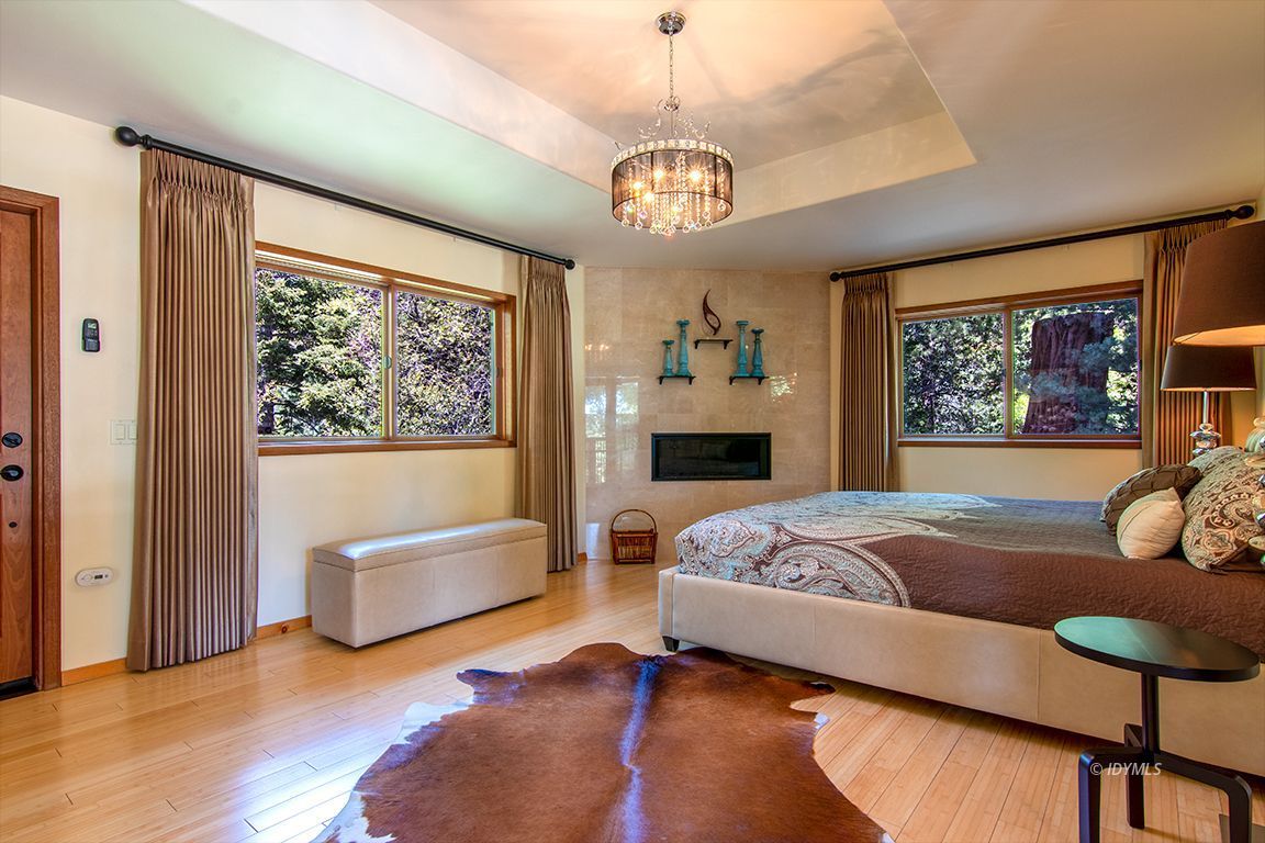 55596 Encino Road Idyllwild, CA 92549 - Photo 41 of 74 a bedroom with a bed and dresser with wooden floor