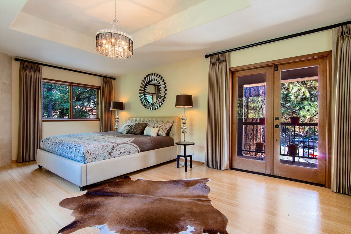 55596 Encino Road Idyllwild, CA 92549 - Photo 42 of 74 a bedroom with a large bed and a chandelier