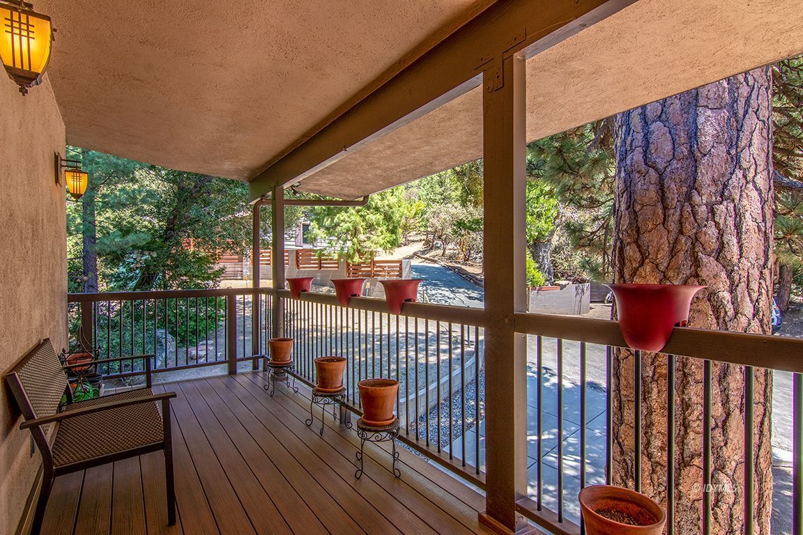 55596 Encino Road Idyllwild, CA 92549 - Photo 45 of 74 a view of a balcony with floor to ceiling windows with wooden floor