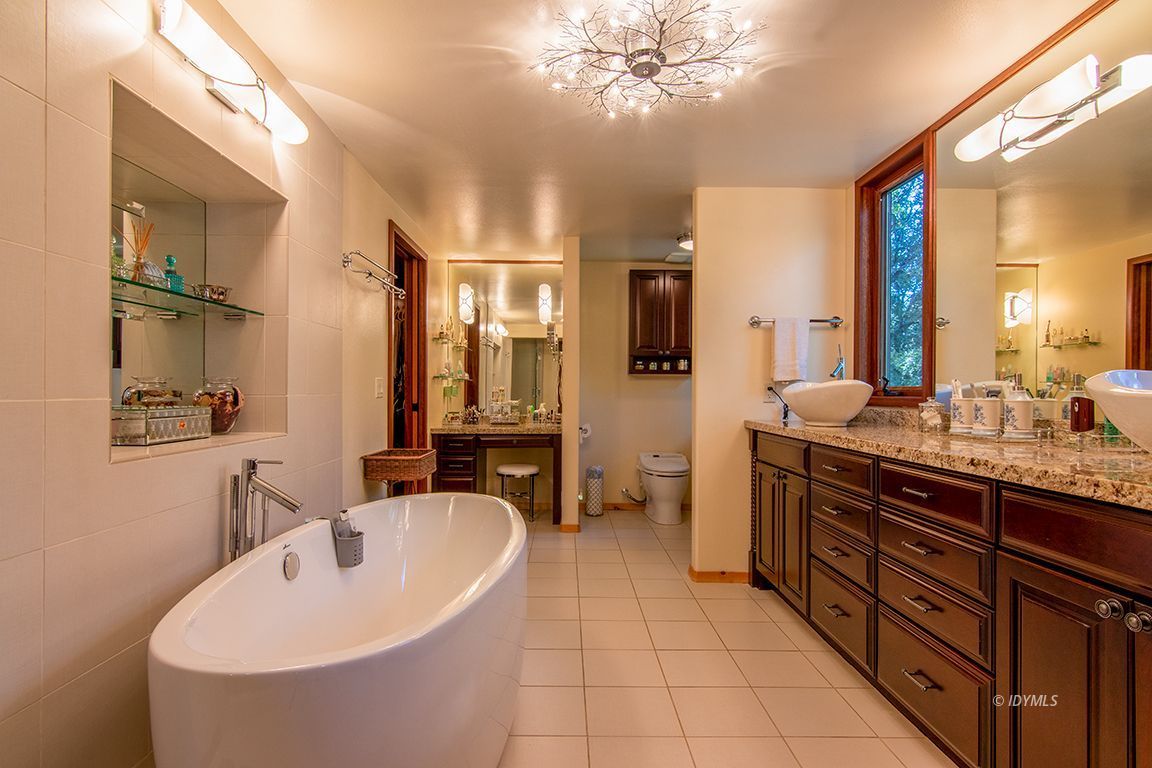 55596 Encino Road Idyllwild, CA 92549 - Photo 48 of 74 a spacious bathroom with a sink double vanity granite tub shower and mirror