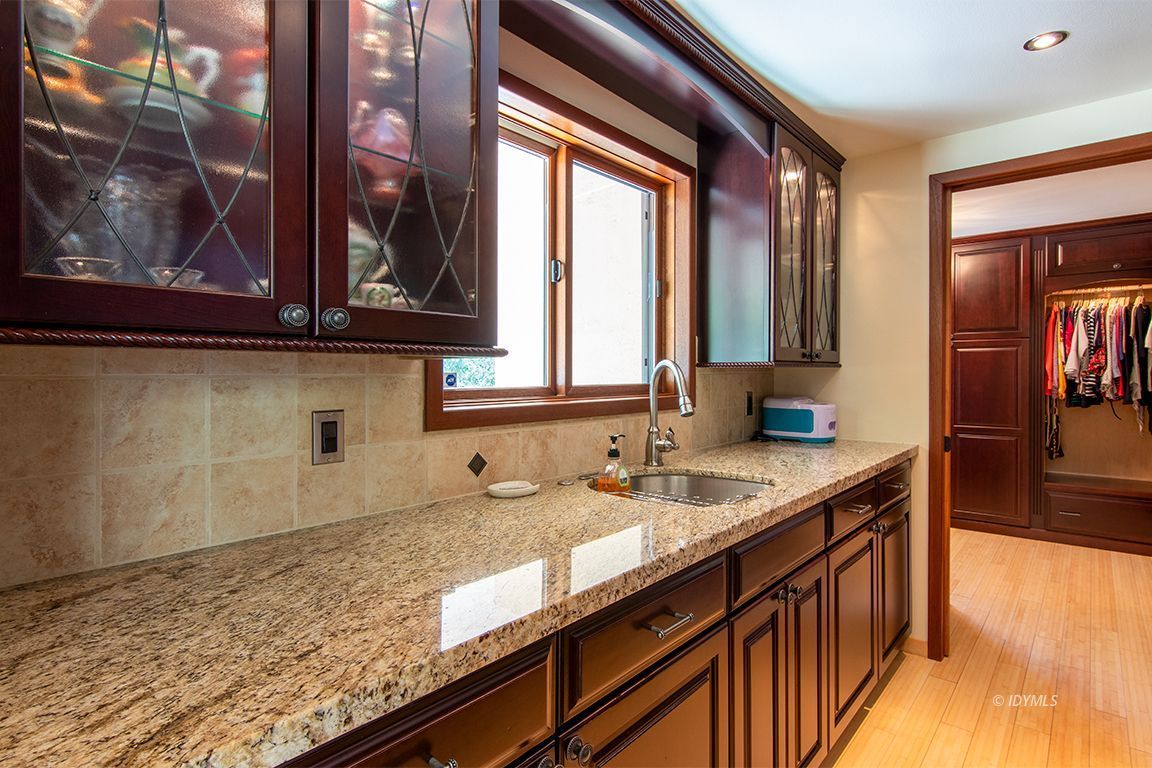 55596 Encino Road Idyllwild, CA 92549 - Photo 55 of 74 a kitchen with granite countertop sink and cabinets