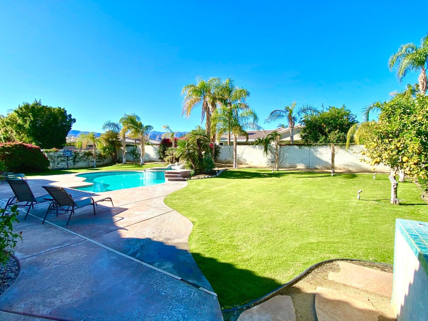 5 Victoria Falls Drive Rancho Mirage, CA 92270 - Photo 4 of 26 a view of a swimming pool and lounge chairs in back yard