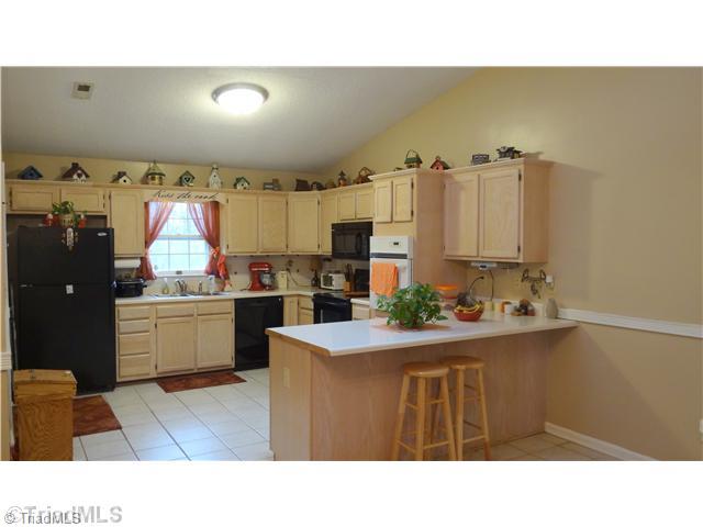 5746 Rolling Meadows Road Randleman, NC 27317 - Photo 8 of 15 Kitchen with vaulted ceilings and skylight