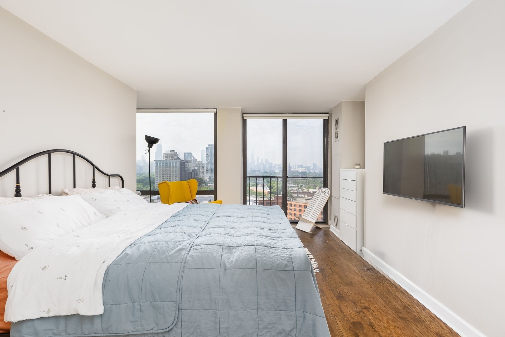 345 West Fullerton Parkway, Unit 1706 Chicago, IL 60614 - Photo 19 of 26 a bedroom with a bed and large windows