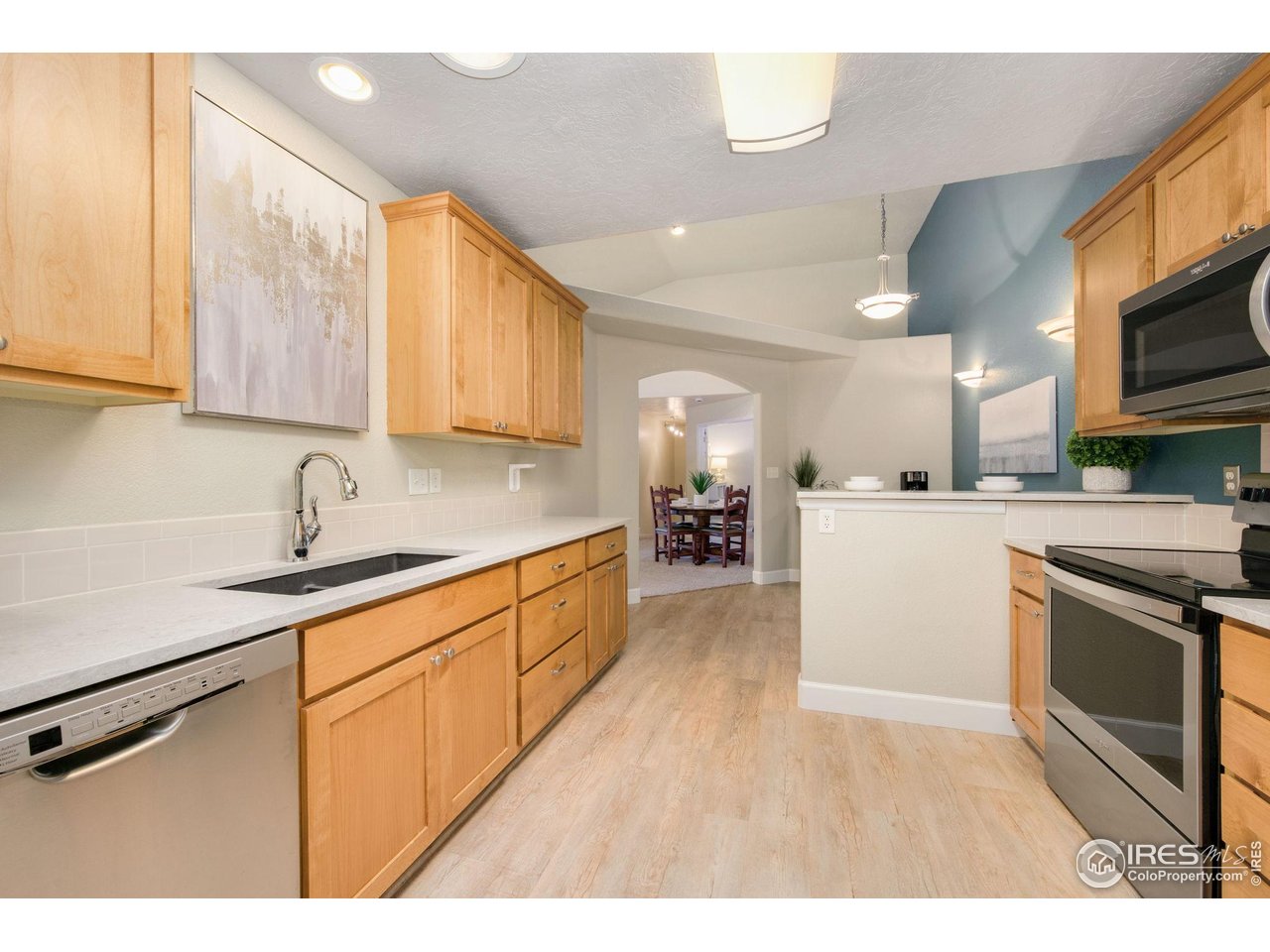 5775 29th Street, Unit 1307 Greeley, CO 80634 - Photo 3 of 28 a kitchen with stainless steel appliances granite countertop a sink and cabinets