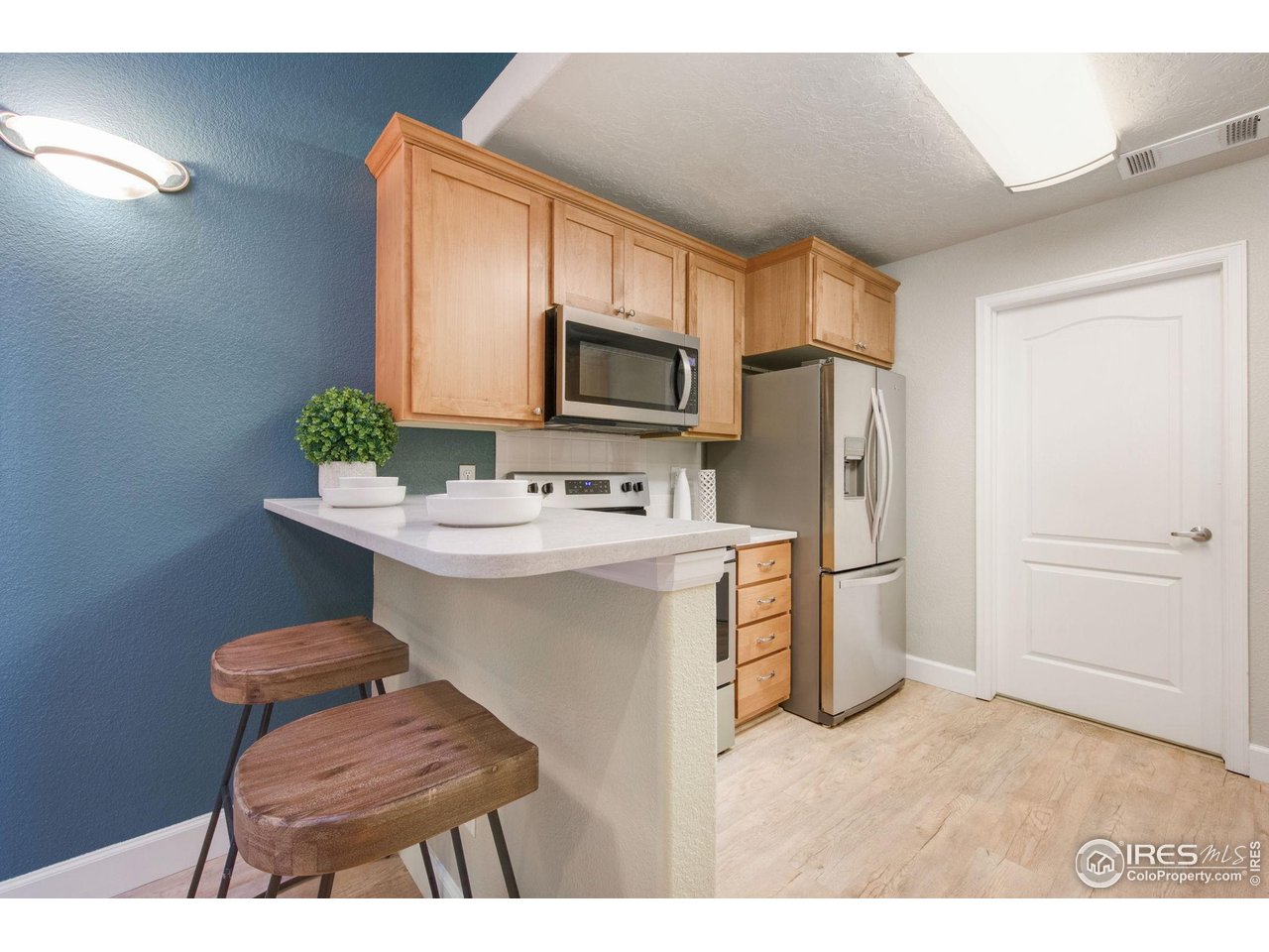 5775 29th Street, Unit 1307 Greeley, CO 80634 - Photo 4 of 28 a kitchen with a refrigerator and a sink