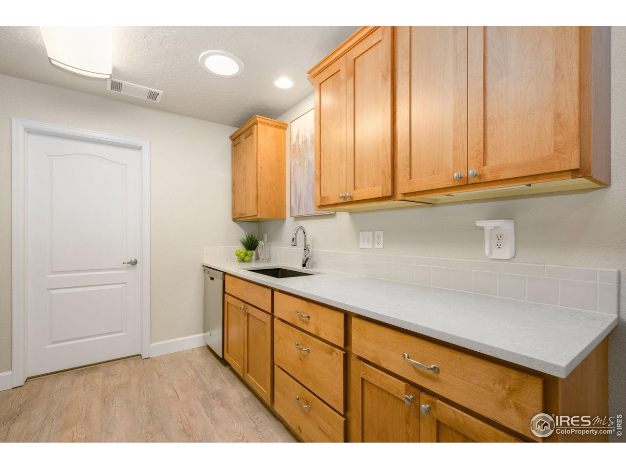 5775 29th Street, Unit 1307 Greeley, CO 80634 - Photo 5 of 28 a kitchen with a sink cabinets and a wooden floor
