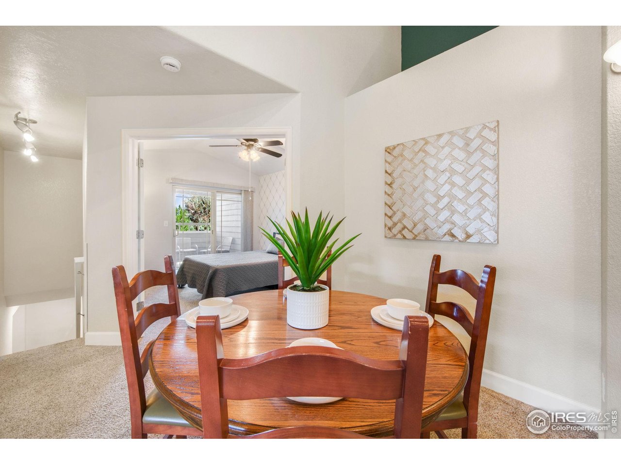 5775 29th Street, Unit 1307 Greeley, CO 80634 - Photo 8 of 28 a view of a dining room with furniture and a potted plant
