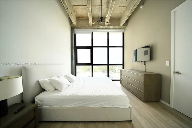 a bedroom with a bed and a window