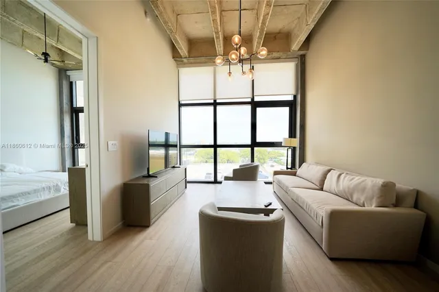 a living room with furniture and a large window