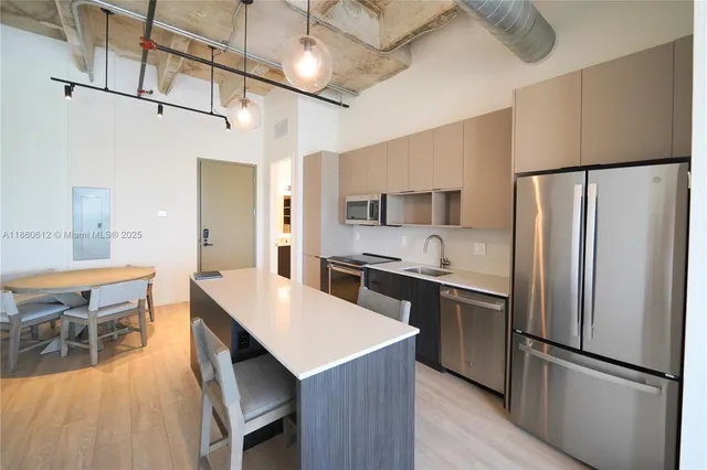 a large kitchen with a table and chairs