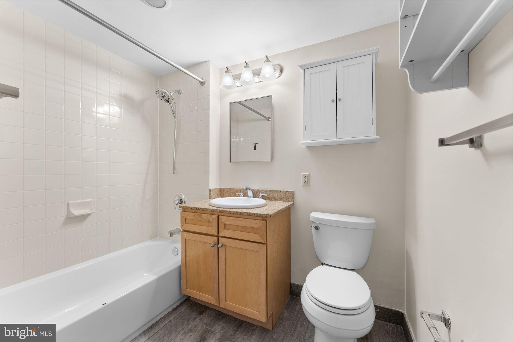 1150 K Street Northwest, Unit 306 Washington, DC 20005 - Photo 11 of 23 a bathroom with a sink a toilet and bathtub