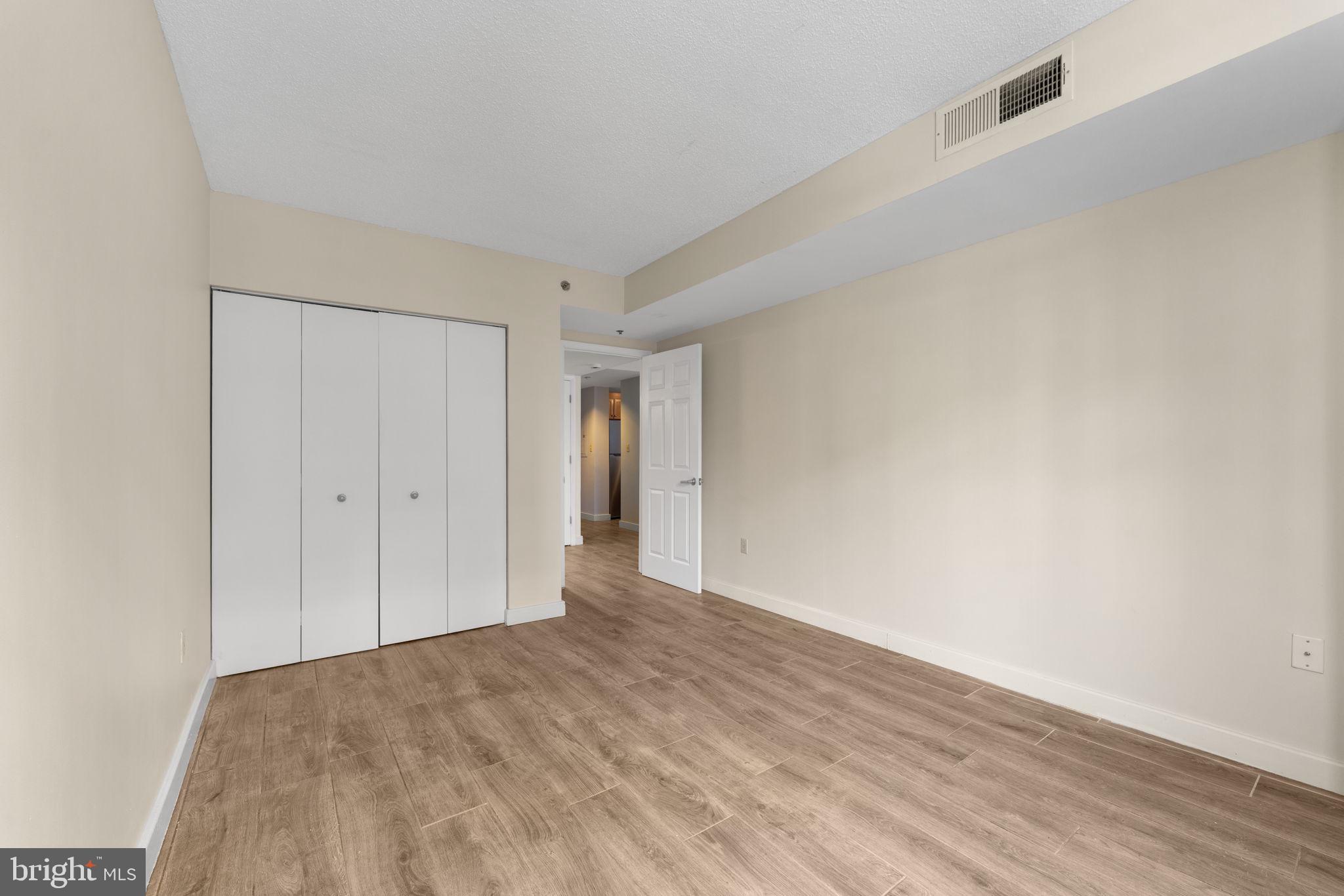 1150 K Street Northwest, Unit 306 Washington, DC 20005 - Photo 17 of 23 a view of an empty room and wooden floor