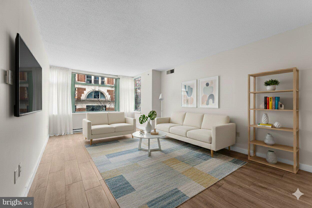 1150 K Street Northwest, Unit 306 Washington, DC 20005 - Photo 7 of 23 a living room with furniture and a couch