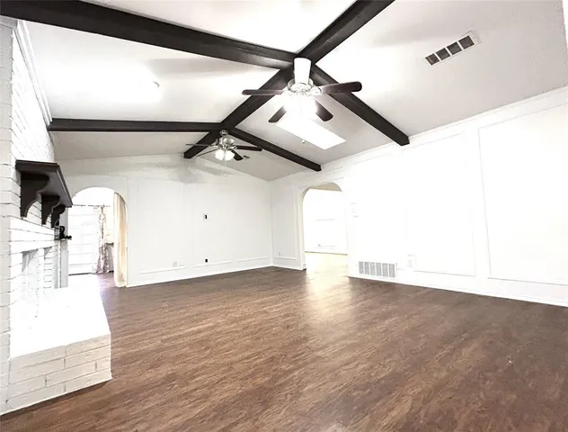 a view of a room with wooden floor and white walls