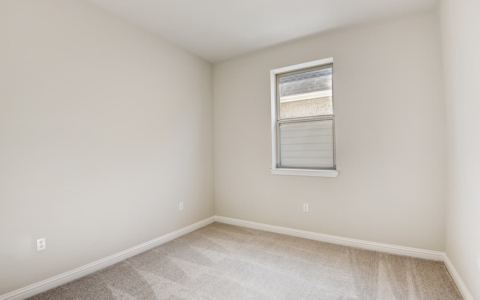 8209 Springsteen Drive Austin, TX 78744 - Photo 5 of 11 Unfurnished room featuring light colored carpet and baseboards