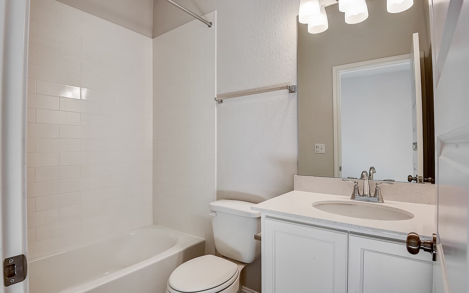 8209 Springsteen Drive Austin, TX 78744 - Photo 7 of 11 Bathroom with vanity, a textured wall, and shower combination