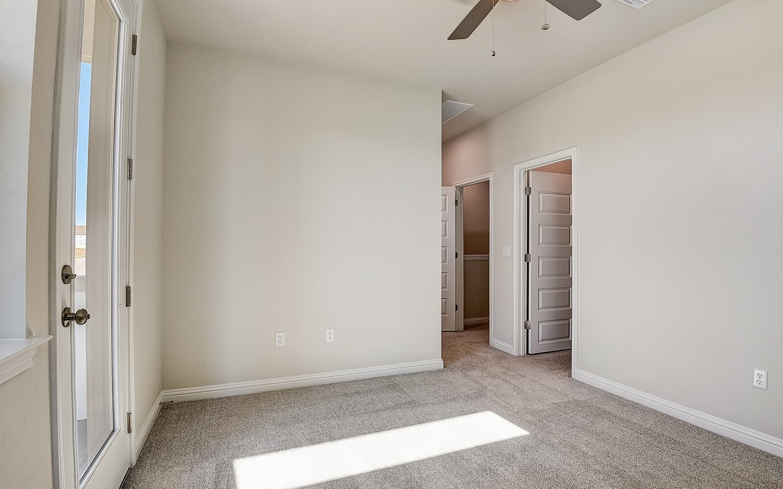 8209 Springsteen Drive Austin, TX 78744 - Photo 8 of 11 Unfurnished bedroom with light colored carpet and ceiling fan